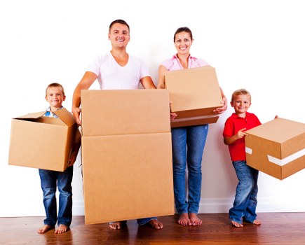 Removal van and moving boxes in Heston residential street