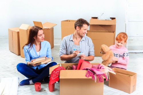 Professional movers carrying furniture during a Heston house move