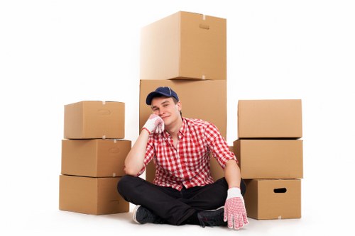 Warehouse worker using safe lifting practices near storage units